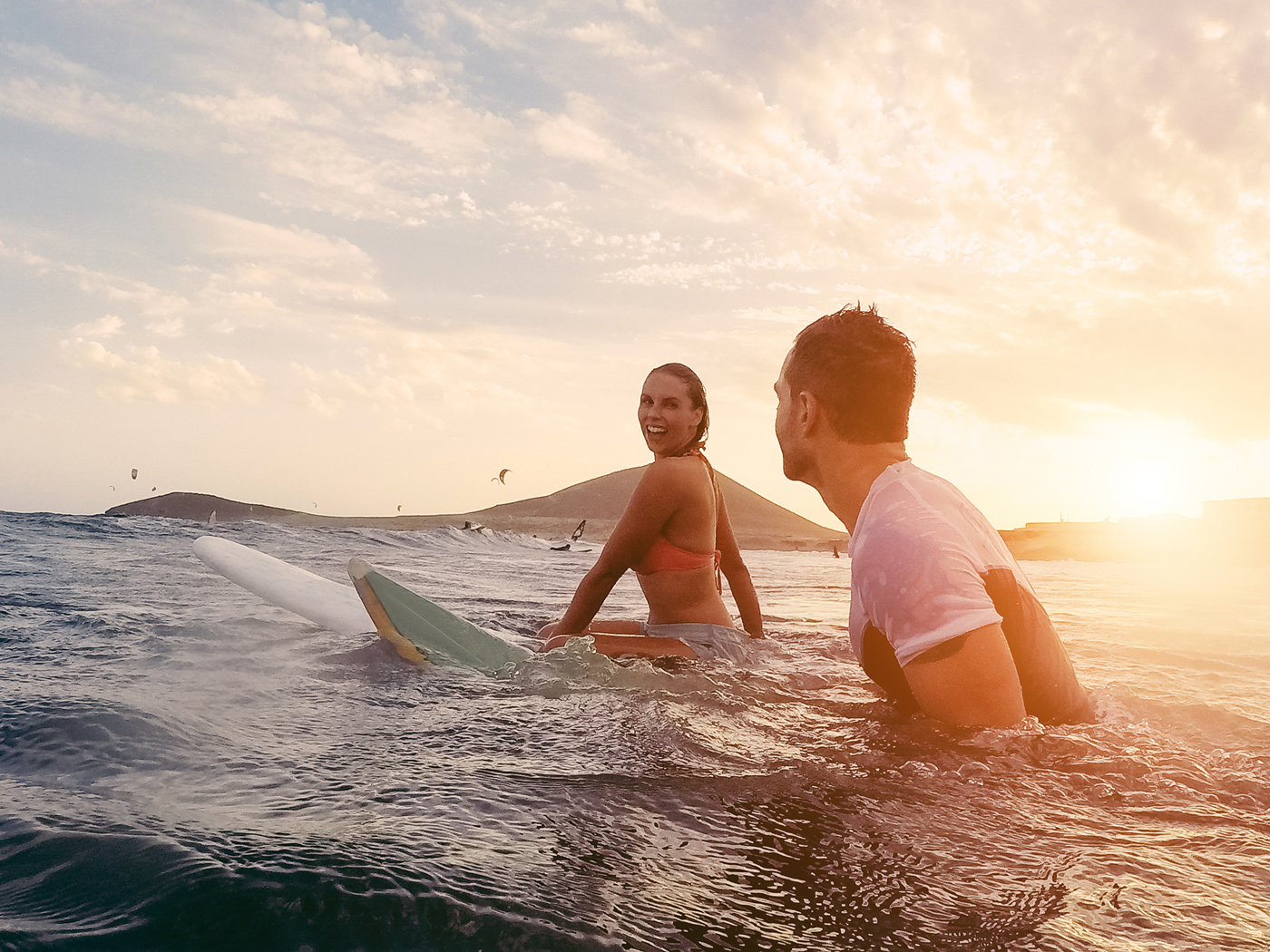 Couple surfing out in the sea